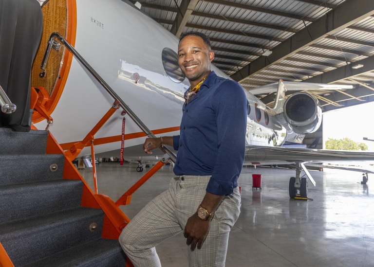 Student at the airstair of a business jet in the hangar